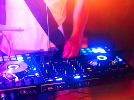Dj mixes the track in the nightclub photo