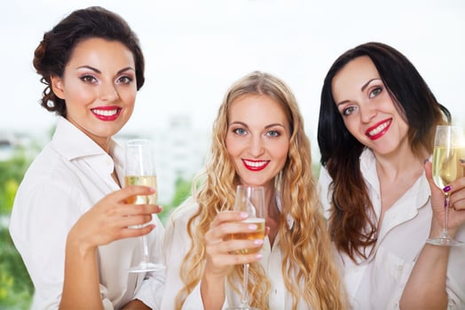 Bride to be and bridemaids holding glass with champagne photo