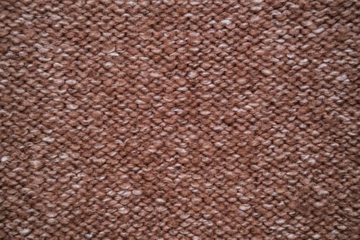 Texture of knitted woolen fabric in brown color photo