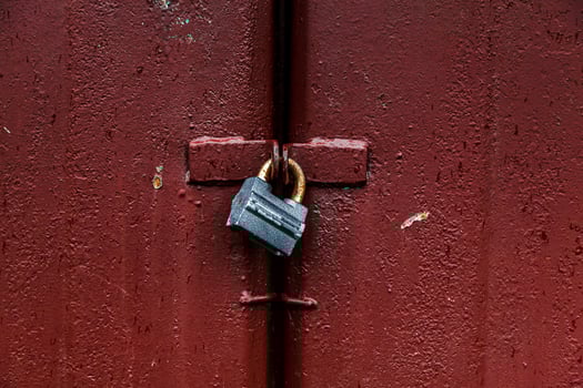 Padlock on red metal door photo