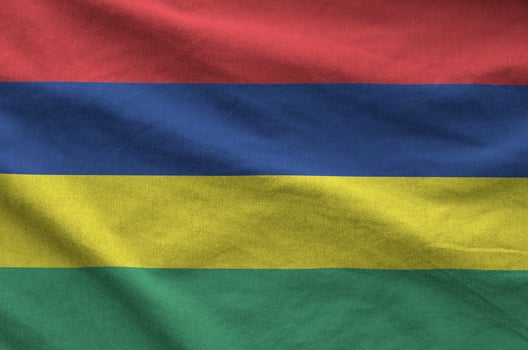 Mauritius flag depicted on folded wavy fabric of old cloth photo