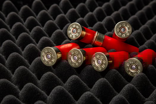 Shotgun shells on foam rubber. Ammunition for 12 gauge smoothbore weapons. Hunting ammunition. Dark back. photo