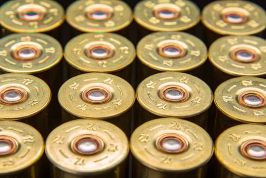 Shotgun shells on a black reflective surface. Ammunition for 12 gauge smoothbore weapons. Hunting ammunition. Dark back. photo