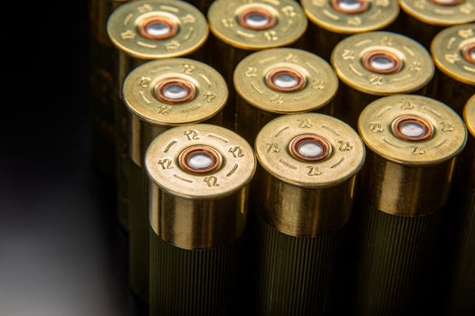 Shotgun shells on a black reflective surface. Ammunition for 12 gauge smoothbore weapons. Hunting ammunition. Dark back. photo