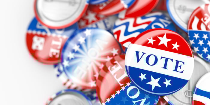 Pile of American red, white, and blue Vote pin. Collection of voting buttons for US presidential election or local elections. 3d render. photo