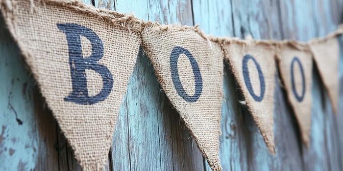 Burlap banner decorates an old wooden wall for Halloween festivities photo