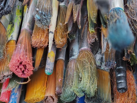 Paintbrush paint in the basket is dirty and old. photo