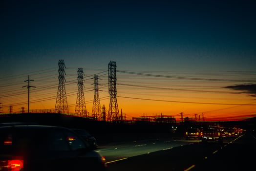 Electric transmission lines against a background of sunset over mountains. photo