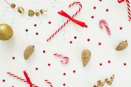 Holidays composition with decoration and candy canes on white. Flat lay, top view photo