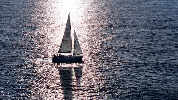 A tranquil sailing adventure in the shimmering waters at sunset, capturing the essence of peaceful nautical exploration photo