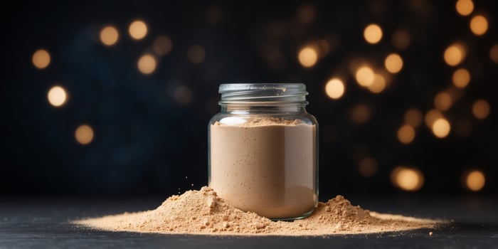 A jar filled with protein powder, surrounded by powder dust, on a dark surface. photo