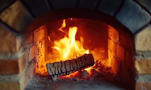 Close-up of flickering flames in a brick fireplace photo