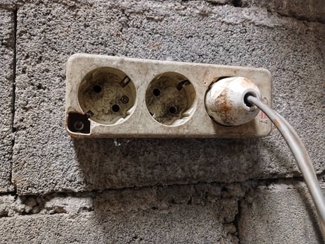 White electrical plug in wall electrical socket photo
