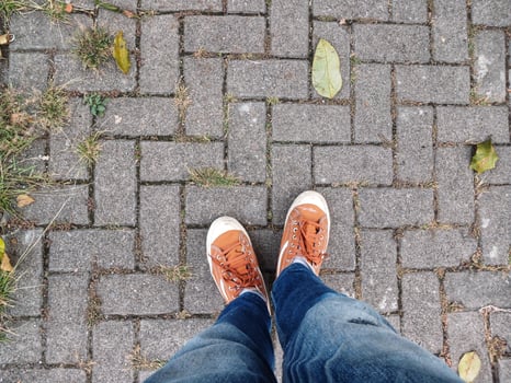 Business man's feet walking on the sidewalk floor photo