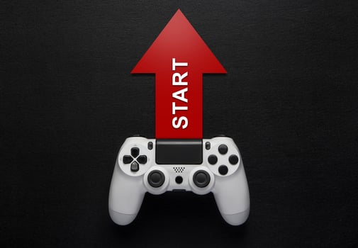 white modewrn gamepad and red arrow with strart on a dark background photo