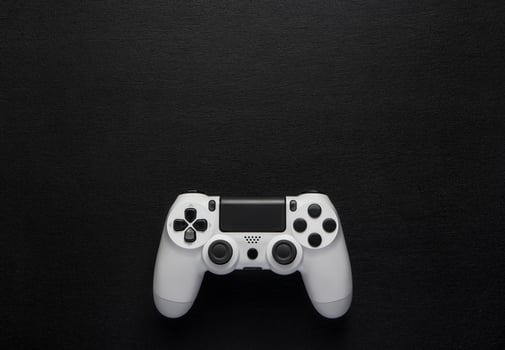 white gamepad on a dark wooden background photo
