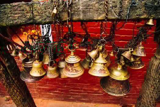 Many golden buddhist bells with wishes in sunlight photo