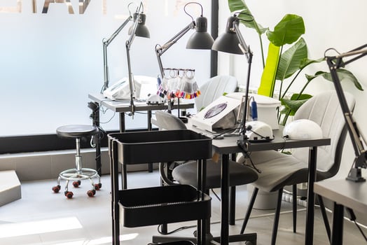 Modern table with nails color palette and lamp situating in salon. Workplace for manicure. Interior concept. photo