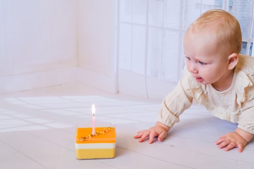 Baby girl celebrating her birthday with birthday cake photo