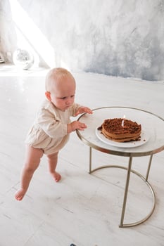 Baby girl celebrating her birthday with birthday cake photo