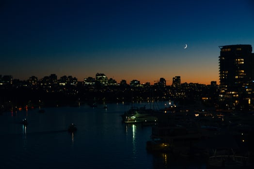 View of buildings illuminated in the city on coastline at Vancouver, Canada photo