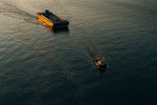 Canadian tugboat departing Vancouver, canada with an Empty rock barge in tow. photo