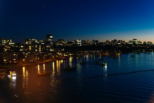 View of buildings illuminated in the city on coastline at Vancouver, Canada. photo