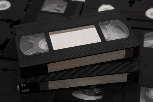 Videotape with blank tags. Pile of VHS cassettes. Vintage media. Isolate on a white back photo