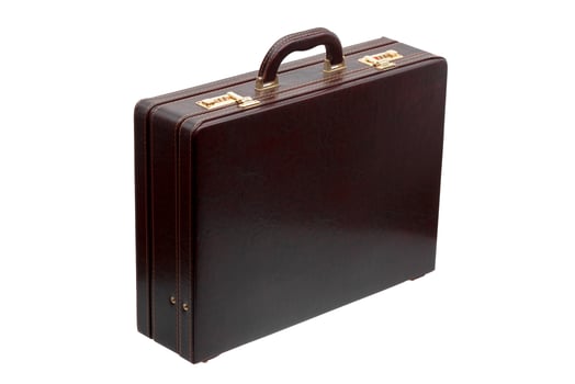 Brown leather suitcase with combination lock and gold locks isolated on white photo