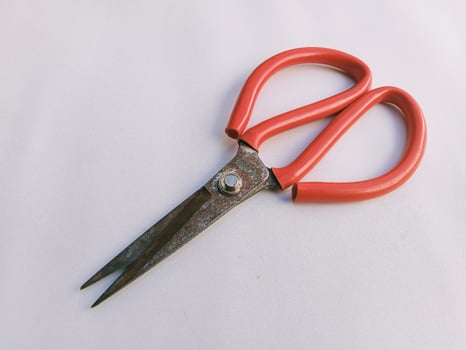 A pair of scissors on a white surface photo