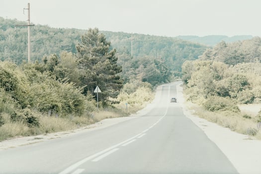 Country Road Through Forested Hills photo