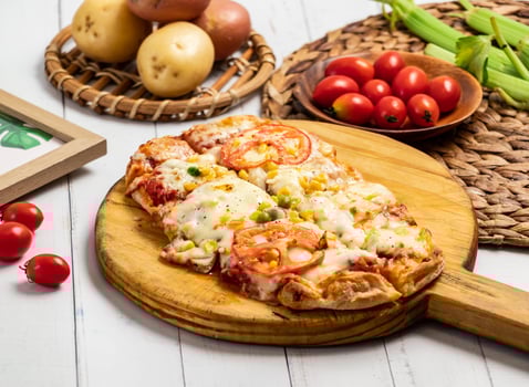 Delicious Tomato, Corn, and Mushroom Pizza with a crispy crust and a bubbly cheese topping isolated on wooden cutting board side view of taiwan fast food photo