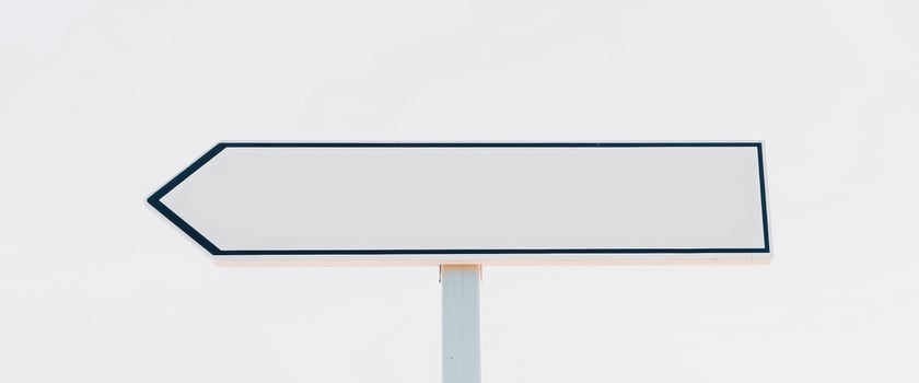 Blank White Signpost Against a Cloudy Sky photo