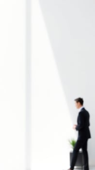 Blurred Businessman Walking in a White Room photo