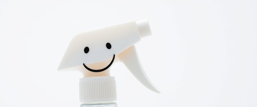 White spray bottle with a smiley face photo
