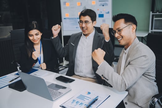 Group of colleagues engaging in a discussion during a business meeting in a conference room. Happy business people, men and women, collaborating and working towards their shared goals. photo