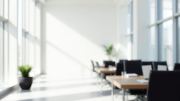 Blurred Modern Office Interior with Sunlight Streaming Through Large Windows photo