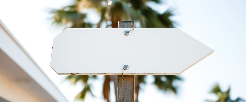 White Arrow Sign with Palm Trees Background photo