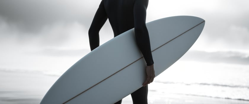 Surfer Carrying Surfboard on Beach photo