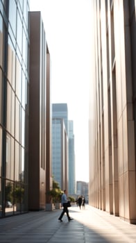 Businessman walking between office buildings in the city photo