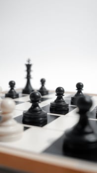 Close Up of Chess Pieces on a Chessboard photo