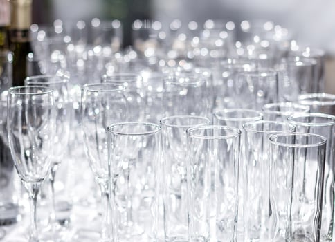 Lots of different empty glasses on the table. Preparing for a banquet, holiday or wedding. Blurred back. photo