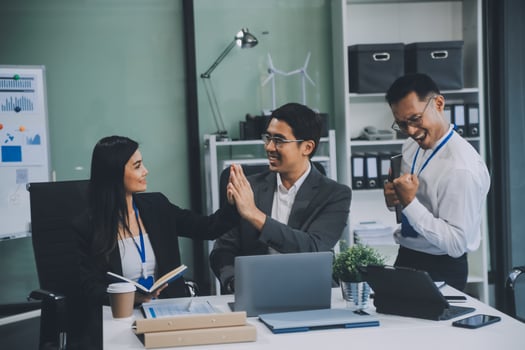 Group of colleagues engaging in a discussion during a business meeting in a conference room. Happy business people, men and women, collaborating and working towards their shared goals. photo