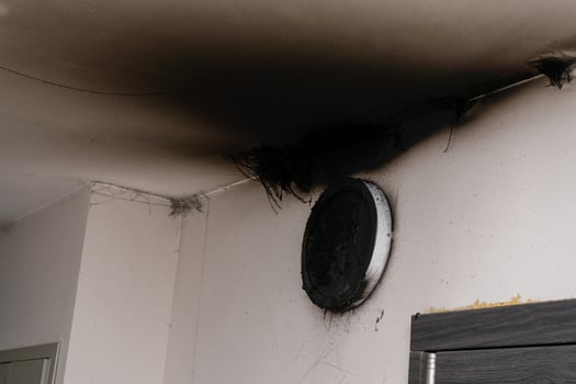 Burnt out LED lamp. A lampshade lamp on the wall after a fire. Spontaneous combustion and fire in a residential building. photo