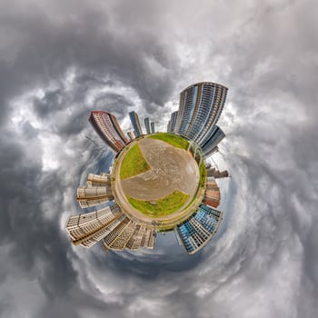 abstract swirling tiny planet spherical panorama of multi-storey buildings of skyscrapers of a residential complex in the form of a butterfly, bugs, crabs in blue sky photo