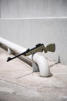 Modern air rifle. Air guns for sports and entertainment. Gray concrete back photo