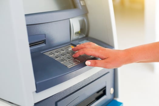 Young tourist woman using banking machine photo