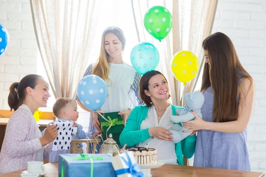Pregnant woman with friends at a baby shower photo