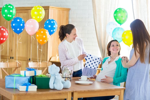 Pregnant woman with friends at a baby shower photo