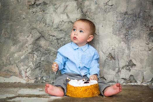Adorable baby smashing cake photo